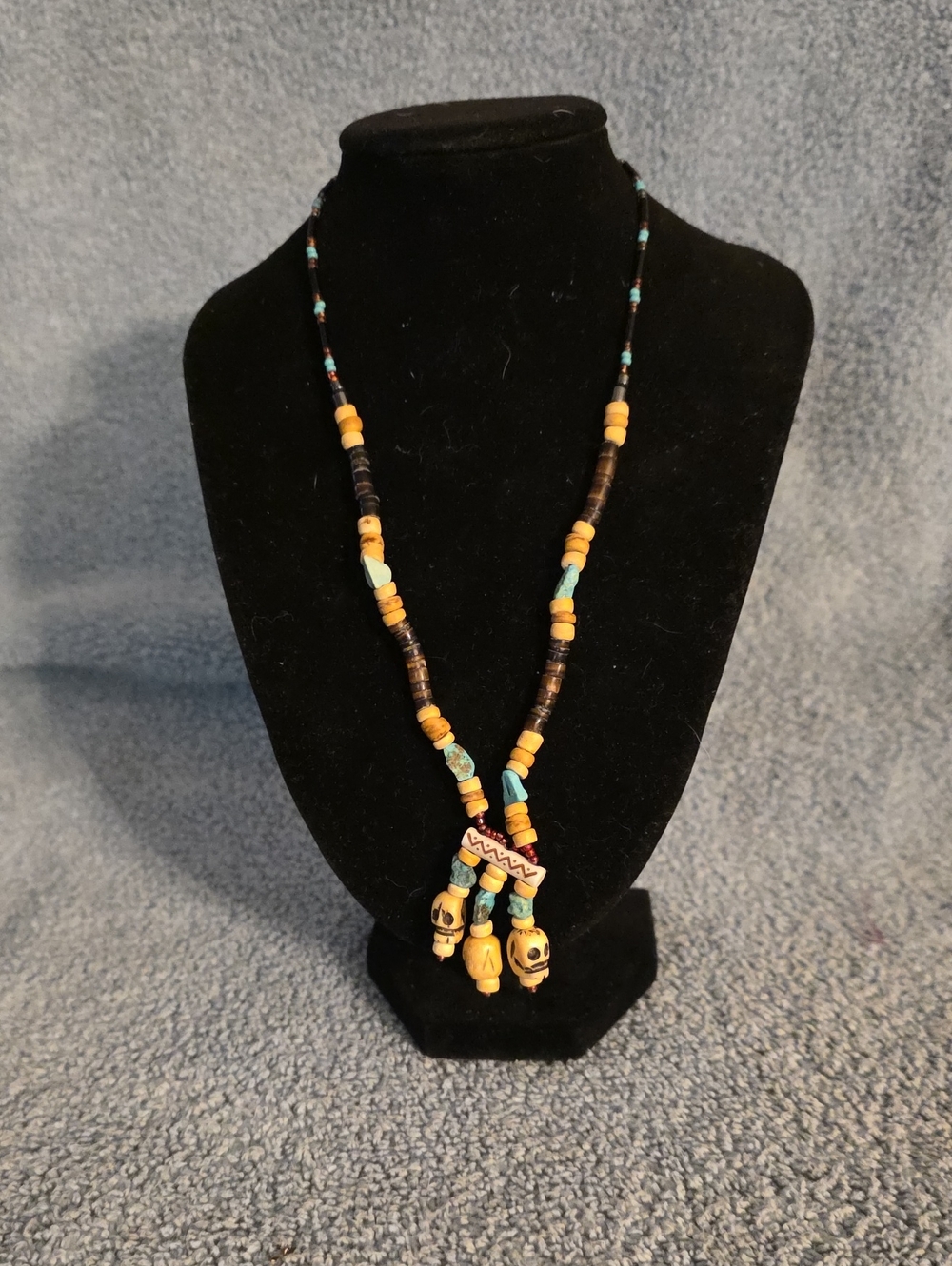 beaded necklace featuring tan, dark brown, & turquoise-colored disc & Tube Beads